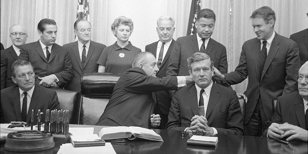 Photo of Members of Kerner Commission seated at table with President Lyndon B. Johnson
