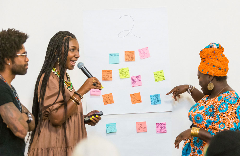 Facilitators read some of the thoughts shared on the response wall following the Black in the Newsroom screening