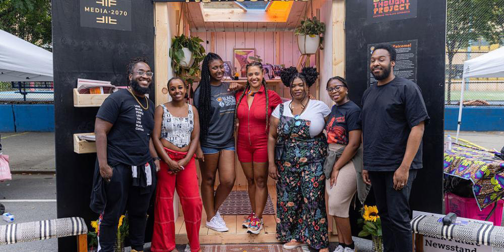 Photo of organizers in front of The Black Future Newsstand